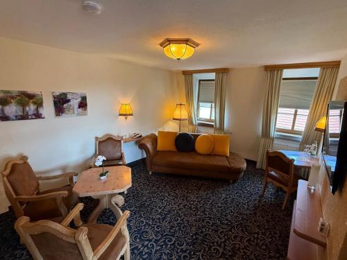 a living room with a couch and a table at Hotel Löwen in Randersacker