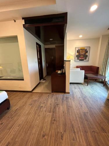 a large living room with a large wooden floor at The Grand Paramont Near Delhi Airport Free Airport Drop in New Delhi