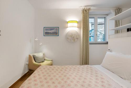 a bedroom with a bed and a chair and a window at Agriturismo Barone Antonio Negri in Fisciano