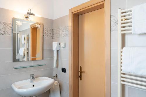 a bathroom with a sink and a mirror at Hotel Mondial in Bellaria-Igea Marina