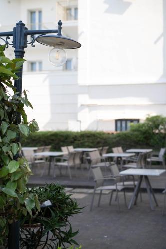 a light on a pole with tables and chairs at Hotel Mondial in Bellaria-Igea Marina