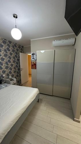a bedroom with a bed and a room with a closet at Il giardino di gianna in Crespellano