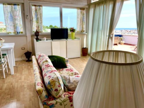 a living room with a couch and a television at Dreaming Penthouse in Vieste