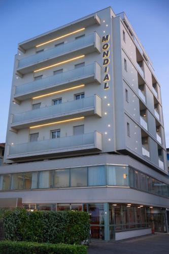 a tall building with a hotel sign on it at Hotel Mondial in Bellaria-Igea Marina
