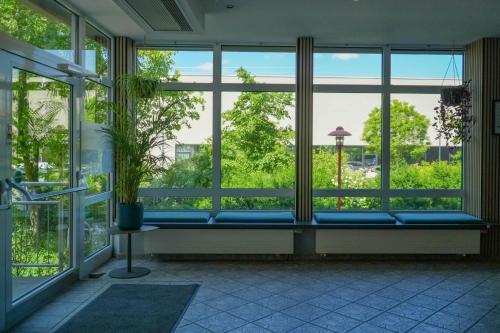 a large window with a blue bench in a room at DJH Jugendherberge Dresden - Jugendgästehaus in Dresden
