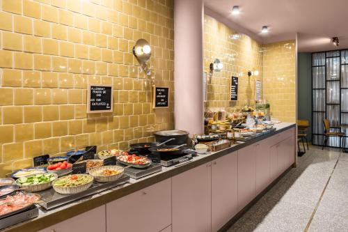 a buffet line with a lot of food on it at Hotel MIO by AMANO in Munich