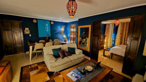 a living room with a couch and a dining room at ORHO Hotel Boutique 15 minuts PTY Airport free shuttle in Tocumen