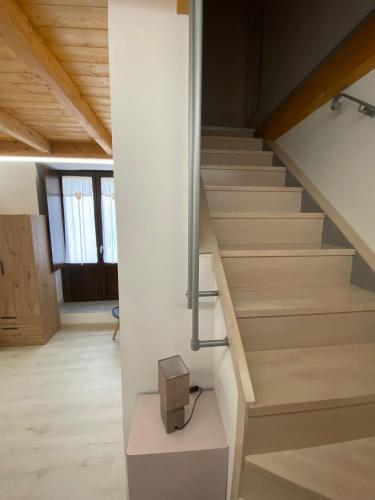 a staircase in a house with a box on a table at B&B vicoli della cattedrale in Melfi