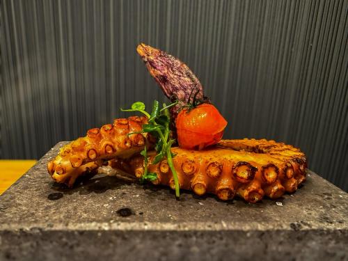 a plate of food with a fish on top at Boutique Hotel beim Lipp - Restaurant & Spa in Roßhaupten