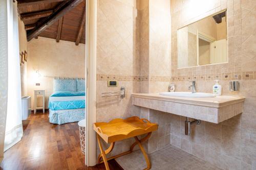 a bathroom with a sink and a mirror at Villa Dei Viandanti in Olìa Speciosa