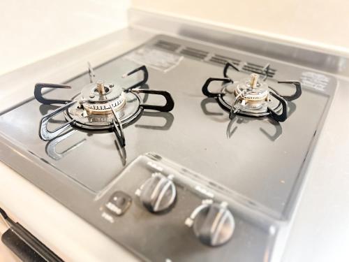 a stove top with two burners on top of it at Prevoyance前原中央 in Itoshima