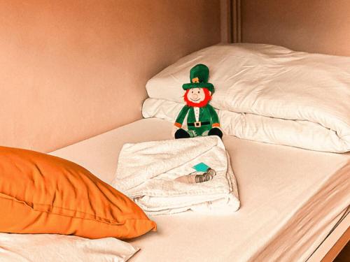 a elf toy sitting on top of a bed at Gardiner House Hostel in Dublin