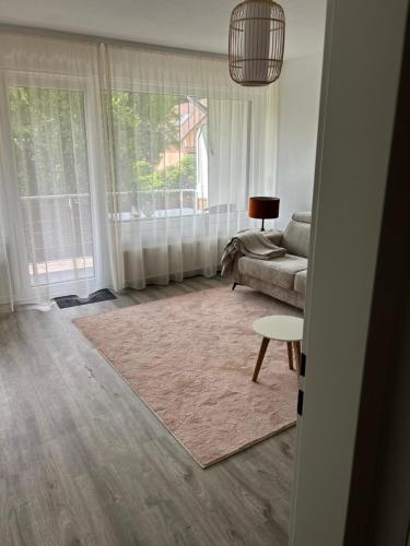 a living room with a couch and a table at Herzlichstharz - Klein und Fein in Bad Lauterberg