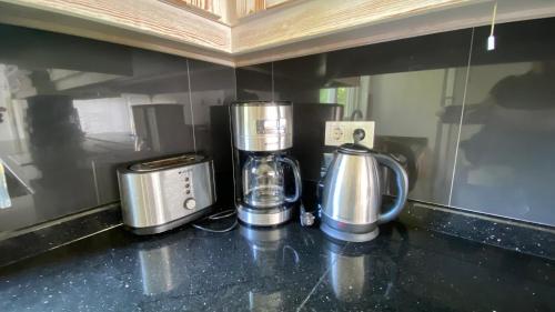a kitchen counter with two coffeemakers and a coffee maker at Akdeniz Villa in Kas