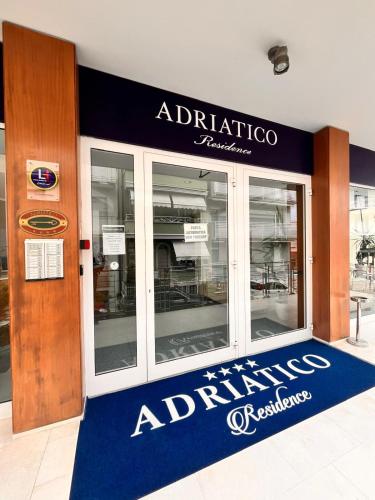a entrance to a restaurant with a sign on the door at Residence Adriatico in Gabicce Mare
