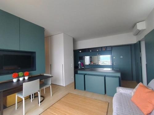 a living room with a couch and a kitchen at Openspace Sunrise lake view in Salò