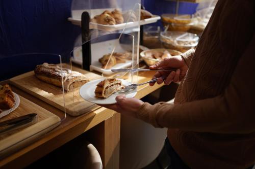 a person holding a plate of food on a counter at Hotel Ristorante Da Tonino in Recanati