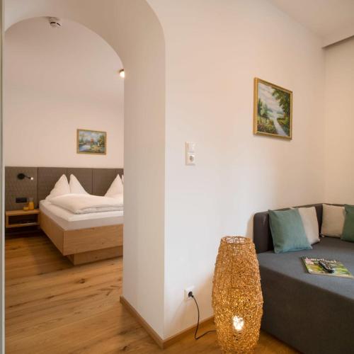 a living room with a couch and a bed at Ferienhof Neusacher Moser in Weissensee