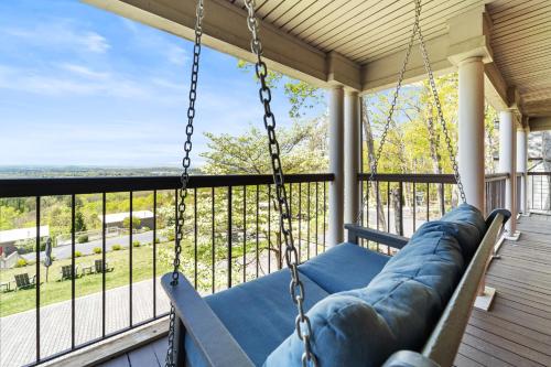 a swing on a porch with a view at Iris Inn and Cabins in Waynesboro