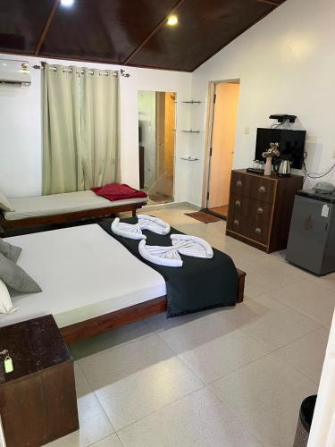a bedroom with two bunk beds and a television at Fatima Guest House in Baga