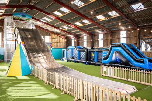 a large indoor playground with a slide and slides at 7, Rabbits Run, Camp Tapnell in Yarmouth