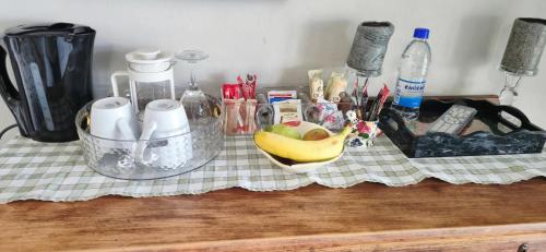 a counter top with a bunch of items on it at Goggas Nest BNB & Restaurant in Matsapha