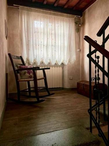 a living room with a table and a window at Casa di Paola in Subbiano
