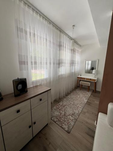 a living room with a dresser and a mirror at Apartmani Gandi in Bihać