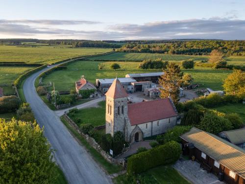 an aerial view of an old church and a road at 2 Bed in Helmsley G0131 in Helmsley