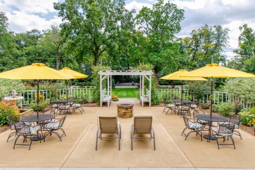 a patio with tables and chairs and umbrellas at Greenway House Bed and Breakfast in Green Lake