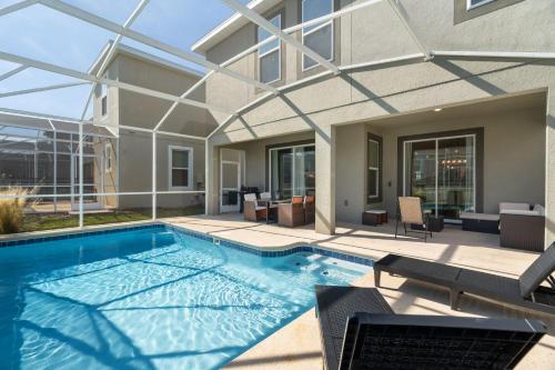 a swimming pool in front of a building at Gorgeous 6-bedroom house with private pool in Kissimmee