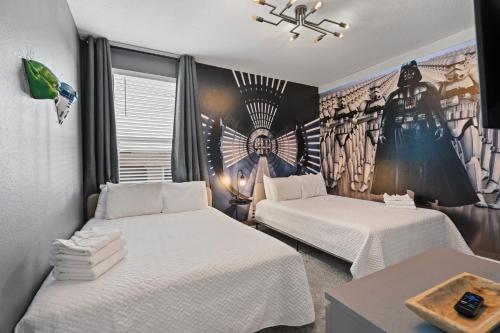 a room with two beds and a mural on the wall at Gorgeous 6-bedroom house with private pool in Kissimmee