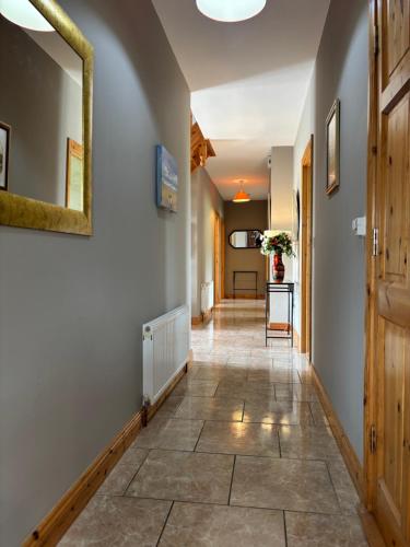a hallway with a tile floor and a mirror at Albert Lock Bungalow in Carrick on Shannon