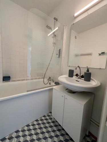 a bathroom with a sink and a shower and a tub at Les terrasses de la Baule in La Baule