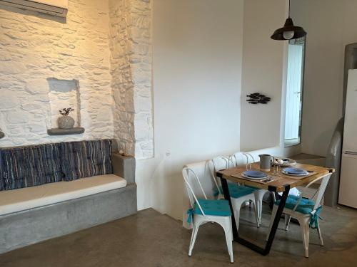 a room with a table and a bench and a table and chairs at Serenity Hill in Kithnos