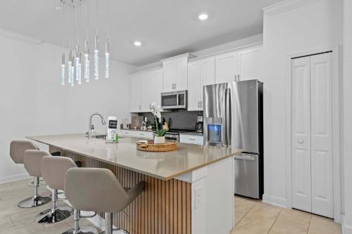 a kitchen with a counter and a refrigerator at Special 4bedroom TH w-private pool next to Disney in Kissimmee