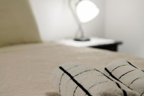 a close up of a white rope laying on a bed at Arazzo Apartments in Vasilikos
