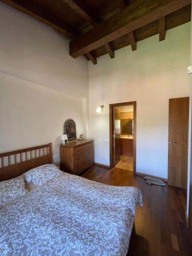 a bedroom with a bed and a dresser in it at House surrounded by mountain and nature in Riu de Cerdanya
