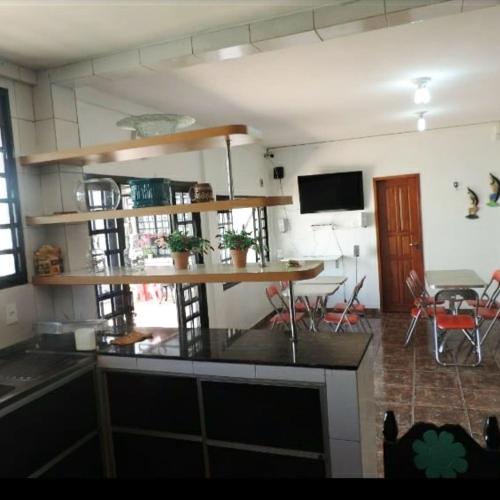a kitchen with a table and a dining room at Hotel Araras in Manaus