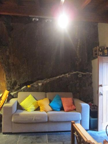 a couch with colorful pillows on it in a room at Casa do Rio Alva in São Pedro de Alva