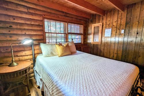 a bedroom with a bed in a log cabin at Hickory Cabin by AvantStay Firepit Hot Tub Game Room Great Location in Palmerton