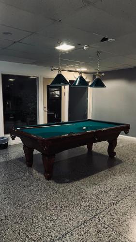 a pool table in a living room with at Rentalux Hostel - Budget Double & Single rooms in Timrå