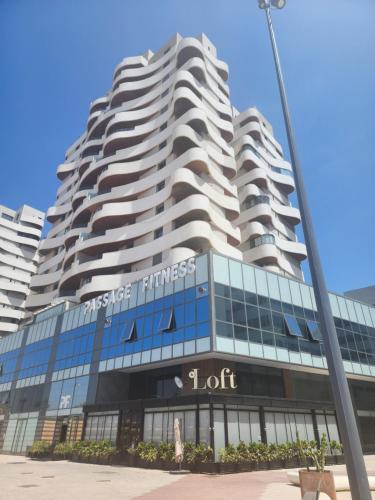 a tall building with a lot sign on it at Casablanca Marina by Saloua in Casablanca