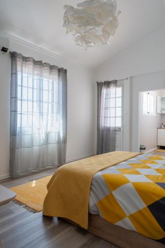 a bedroom with a bed and a chandelier at Villa-Kasia Ocean View Studios in Caniço