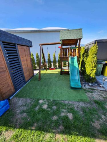 a backyard with a playground with a slide at Apartmány K&K in Liptovský Hrádok
