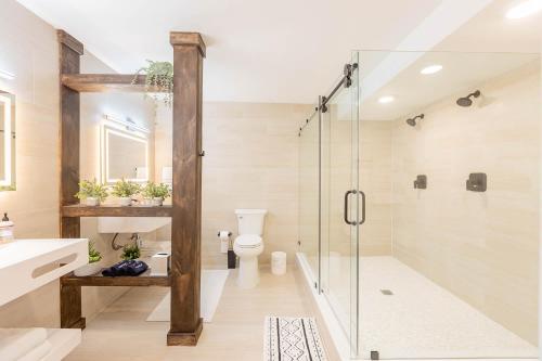 a bathroom with a glass shower and a toilet at Gorgeous Beach Front Condo Near Flagler Ave - 701 in New Smyrna Beach