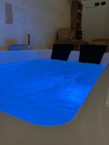 a table with a blue sheet on top of it at Wine Suite in Torricella
