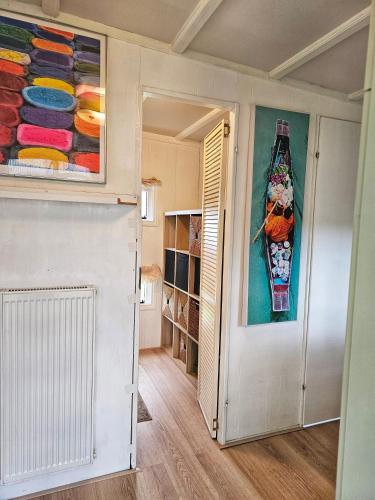 a room with a painting of a boat on the wall at natuur huisje in Anloo