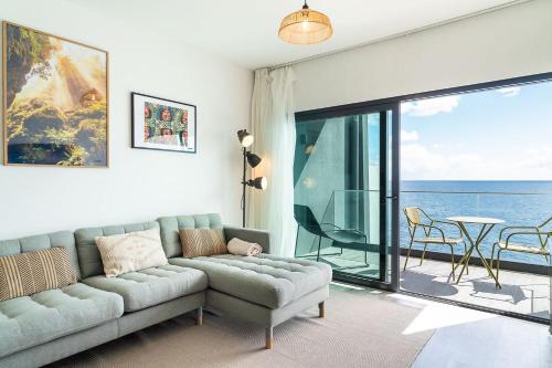 a living room with a couch and a view of the ocean at GuestReady - Endless Ocean Views in Santa Cruz