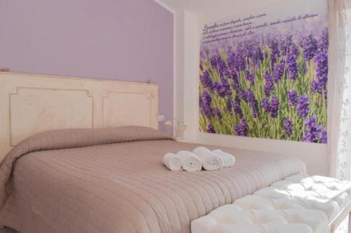 Postel nebo postele na pokoji v ubytování Domus Aromatica, profumo d'Assisi, profumo di casa